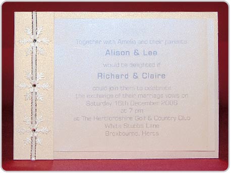 Wedding invitation with snowflake and ribbon detailing down the side